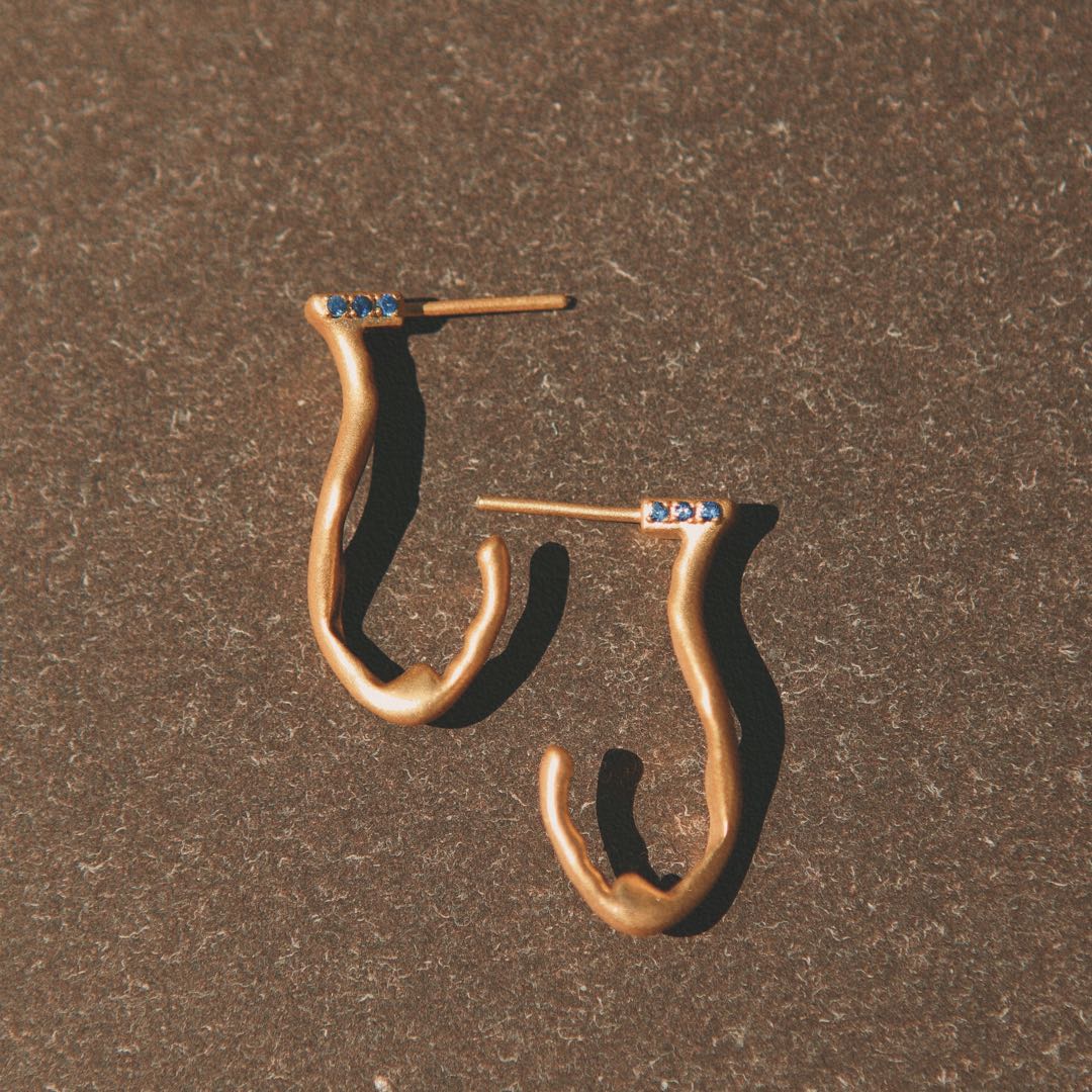 Yiru.jewellery Queen of Cups earrings featuring elegant gold and gemstone accents hanging from delicate hooks.