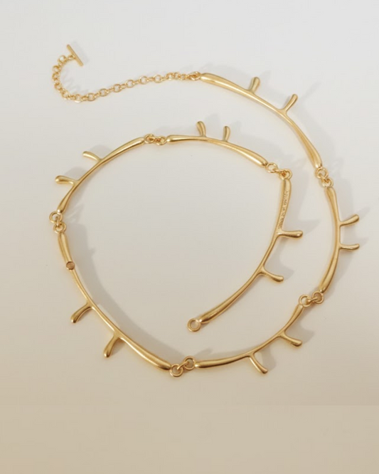 Gold branch-shaped sterling silver necklace by yiru.jeweller on white background