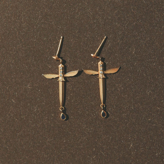 Yiru.jewellery Queen of Swords earrings featuring intricate silver sword and crown design with gemstone accents