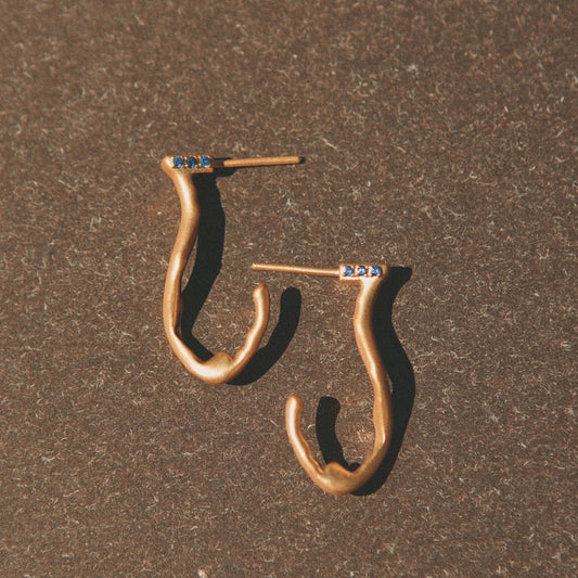 Yiru.jewellery Queen of Cups earrings featuring elegant gold and gemstone accents hanging from delicate hooks.