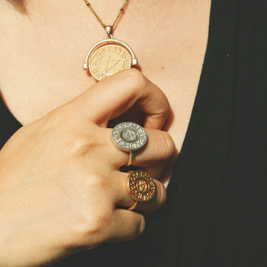 Silver pentacle signet ring by yiru.jewellery featuring a detailed pentagram engraved on a polished band.