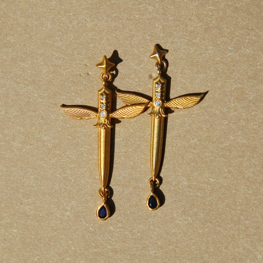 Yiru.jewellery Queen of Swords earrings featuring intricate sword-shaped design with sparkling gemstones on a white background.