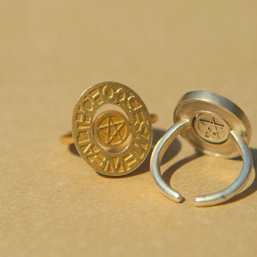 Gold pentacle signet ring from yiru.jewellery with engraved mystical pentagram design on a smooth band.