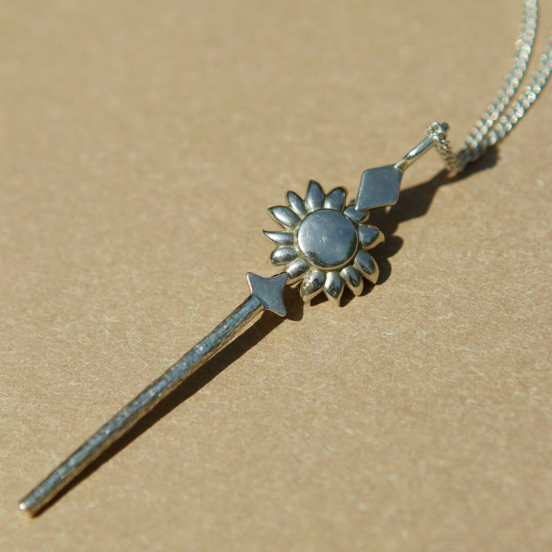 Yiru.jewellery Queen of Wands pendant featuring a detailed design with gold and gemstone accents on a chain.