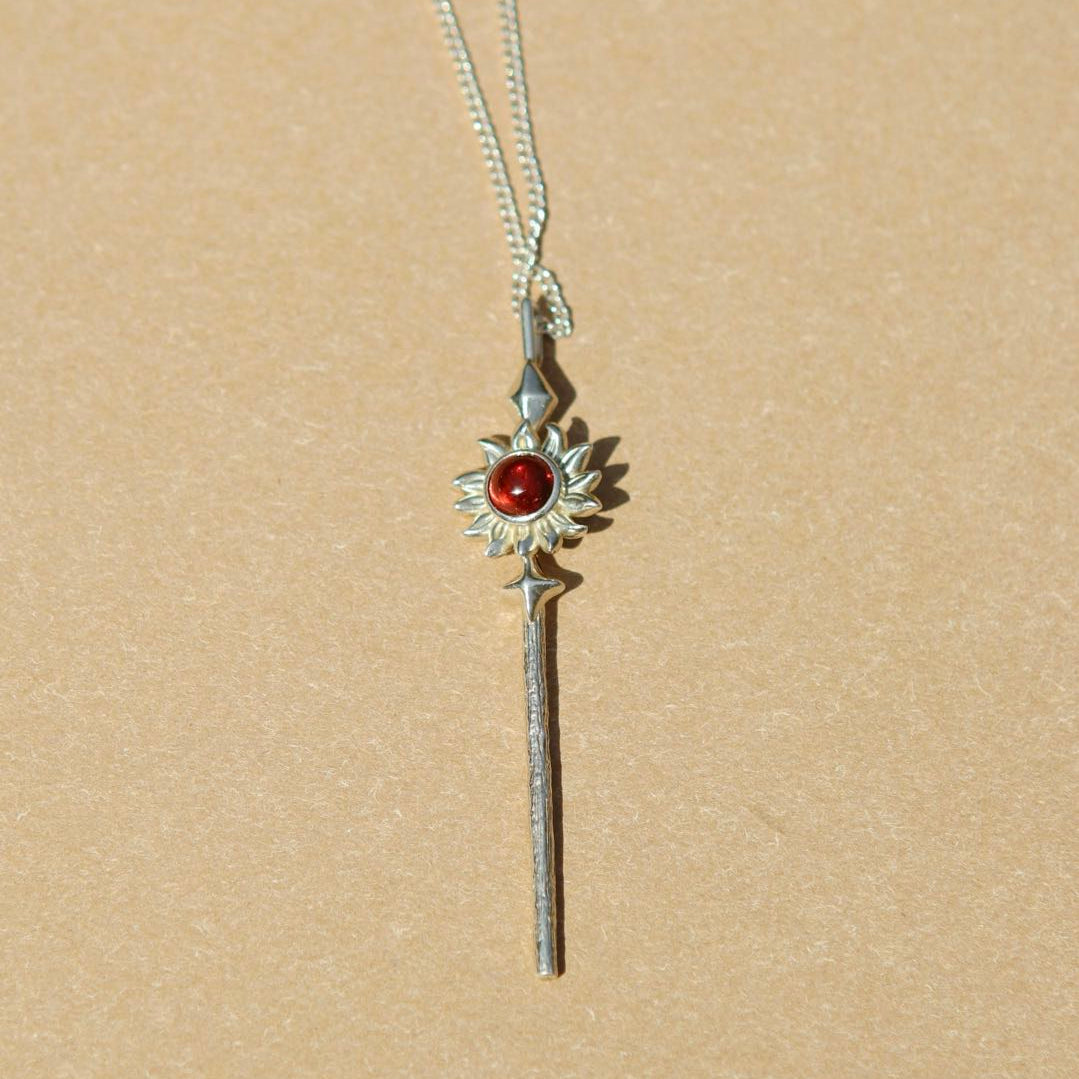Yiru.jewellery Queen of Wands pendant featuring intricate design with gold and gemstone accents on a chain.
