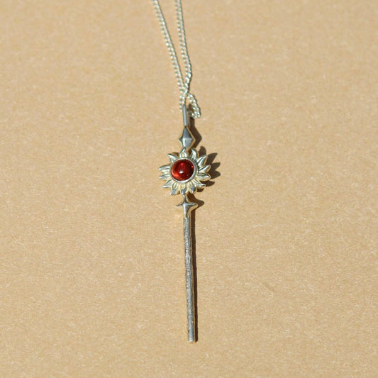 Yiru.jewellery Queen of Wands pendant featuring intricate design with gold and gemstone accents on a chain.