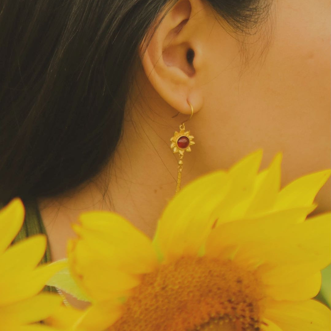 Yiru.jewellery Queen of Wands earrings featuring intricate gold and gemstone designs hanging from elegant hooks.