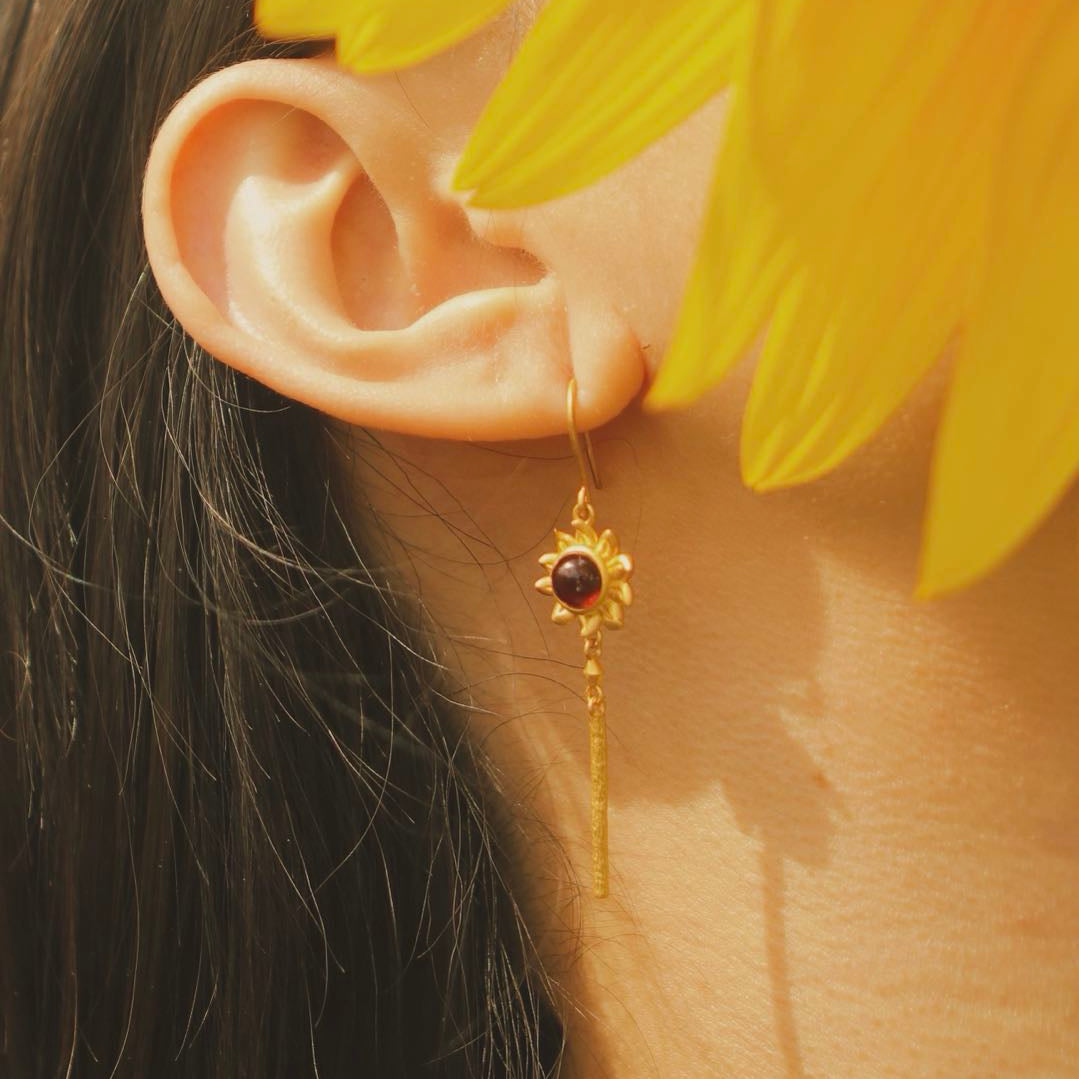 Yiru.jewellery Queen of Wands earrings featuring intricate design with gold and gemstone accents, hanging from elegant hooks.