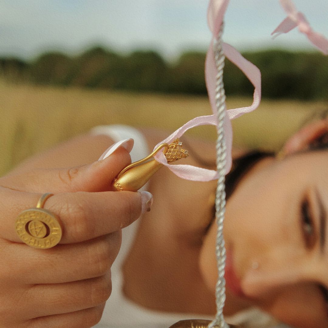 Yiru.jewellery Queen of Cups pendant featuring a detailed, artistic design on a silver chain.