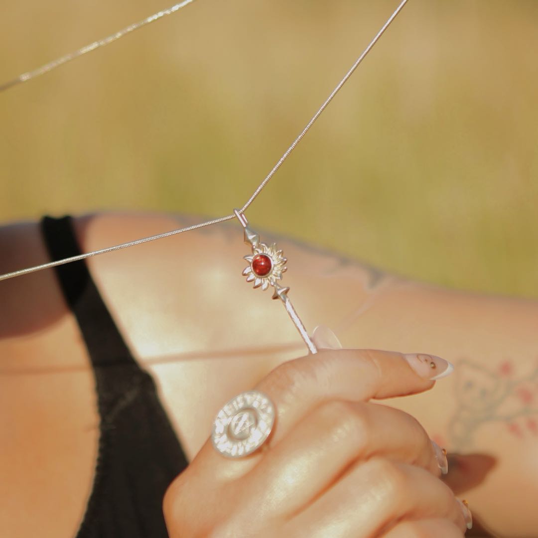 Gold Queen of Wands pendant by Yiru Jewelry featuring intricate design and detailed craftsmanship on a black background.