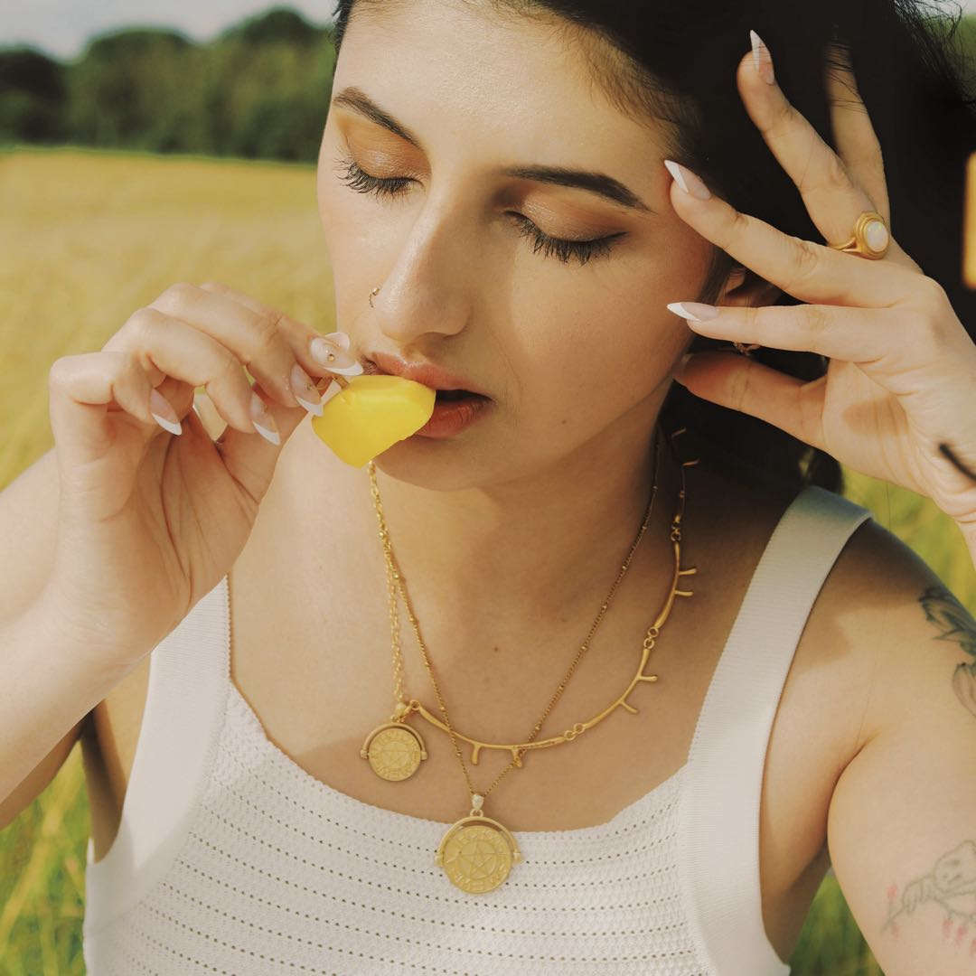 Yiru.jewellery pentacle signet pendant featuring a circular metal design with intricate occult symbol engravings.