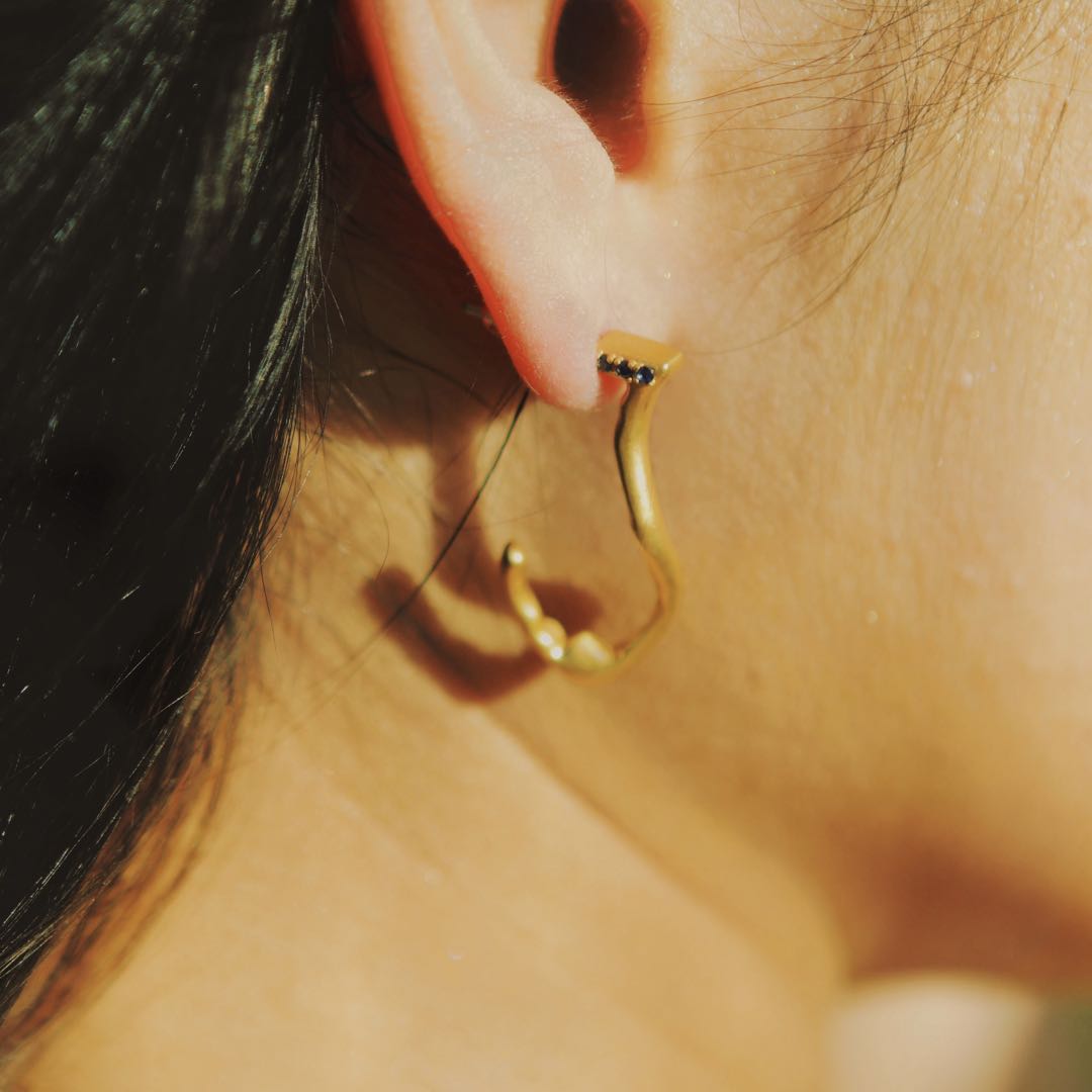 Yiru.jewellery Queen of Cups earrings featuring elegant, silver-toned designs with intricate detailing on a white background.