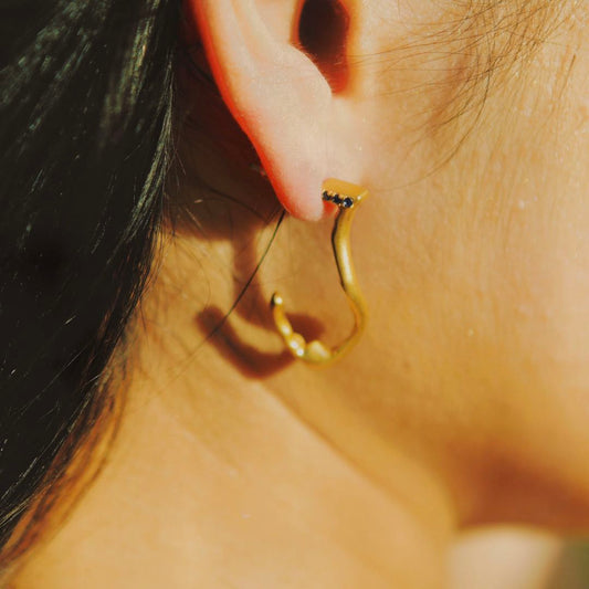 Yiru.jewellery Queen of Cups earrings featuring elegant, silver-toned designs with intricate detailing on a white background.